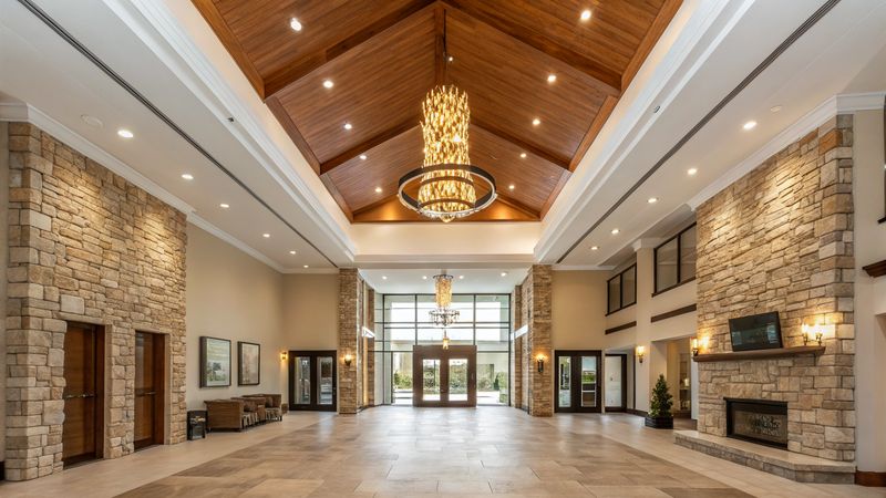 Corporate building lobby with stone accents and chandelier